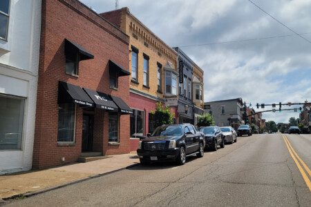 Brick storefronts with black awnings along historic downtown Millersburg