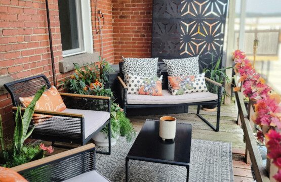 Private deck styled for autumn with seating, fall pillows, and greenery