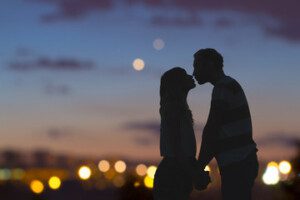 Couple kissing at sunset — a romantic getaway in Ohio's Amish Country