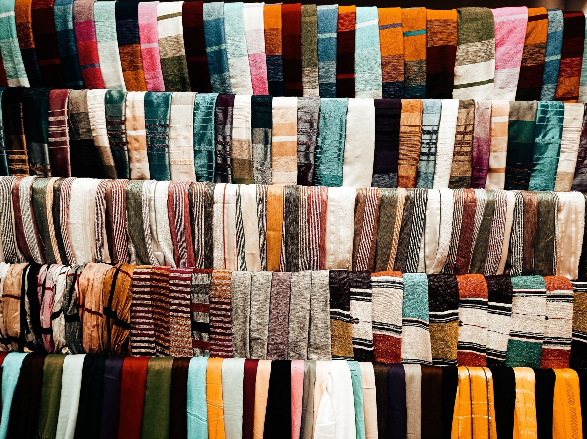 Colorful handmade quilts hanging in a fabric and quilt shop in Ohio's Amish Country
