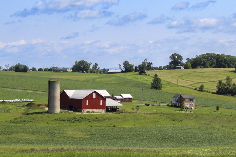 Rolling Amish farmland along the Amish Country Byway at sunset