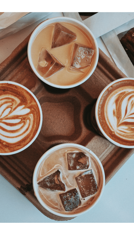 Coffee run on a girls' weekend in Holmes County — two lattes and two iced coffees in a takeout tray